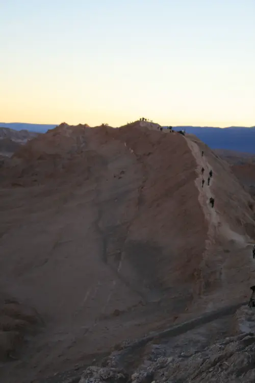 Climbing another giant sand dune at sunset